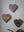 Heart mosaics on the wall surrounded by plants