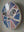 Side view of a circular bat mosaic artwork, showing the rustic wood edge.