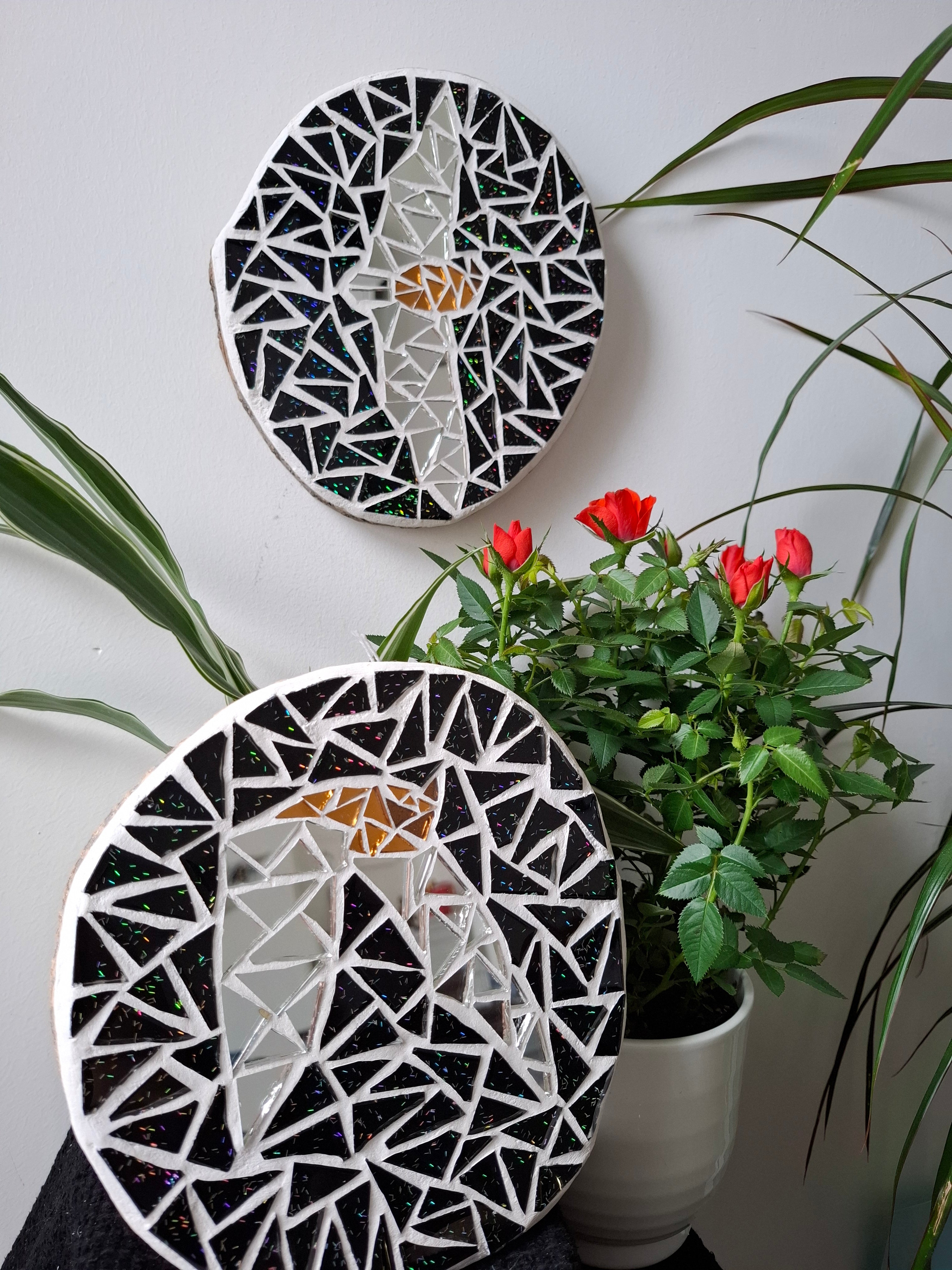 Bat mosaics on the wall surrounded by plants 
