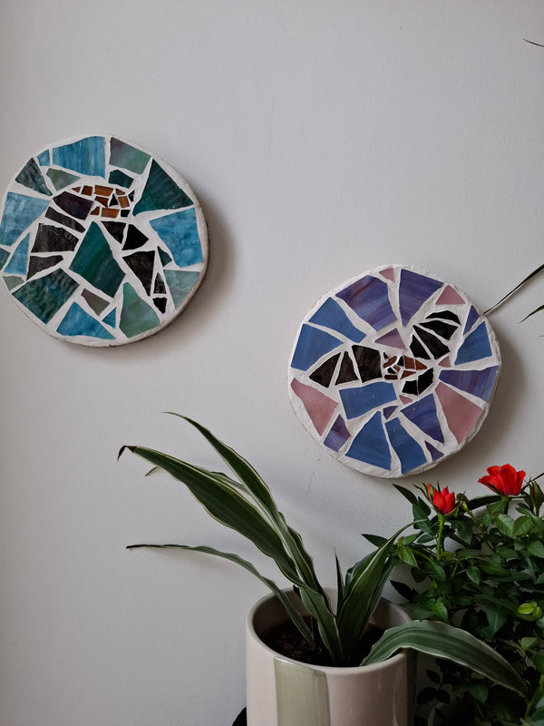 Bat mosaics on the wall surrounded by plants 