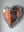 Side view of a heart shaped mosaic artwork, showing the rustic wood edge.