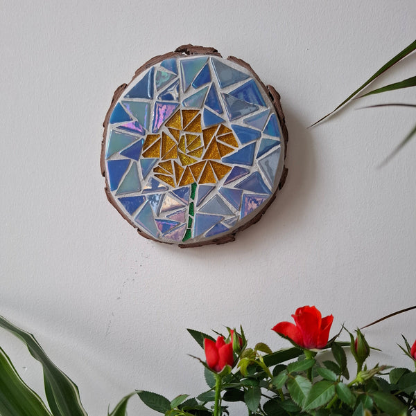 Buttercup mosaic on the wall surrounded by plants

