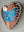 Side view of a heart shaped butterfly mosaic artwork, showing the rustic wood edge.