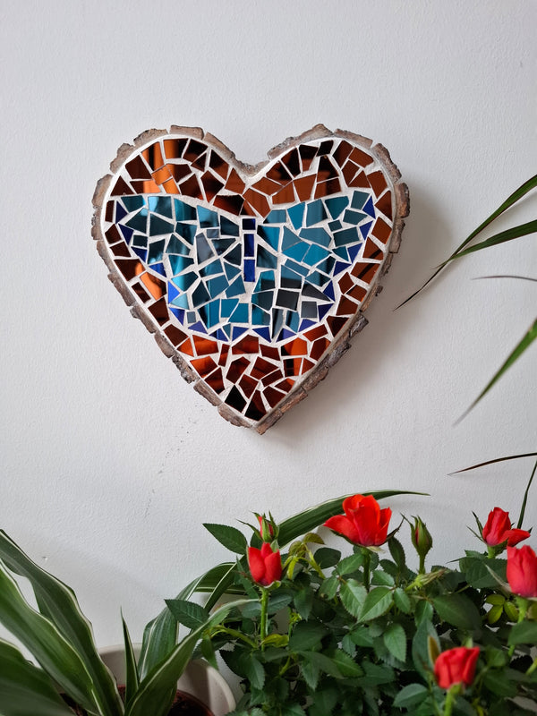 Butterfly mosaic on the wall surrounded by plants