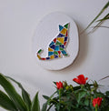 Cat mosaic on the wall surrounded by plants