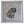 A circular mosaic wall art piece featuring a stylized parrot in green, red, purple, and yellow tones, mounted inside a white square shadow box frame.