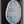 A circular mosaic wall art piece featuring a stylized cat silhouette, mounted in a black frame. The artwork is made of blue, purple, and white patterned glass tiles with a natural wood slice edge.
