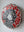 Side view of a circular dog mosaic artwork, showing the rustic wood edge.