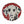 Circular mosaic wall art featuring a stylized dog design. Crafted with glittery black and white glass pieces on a sparkly red background, set on rustic wood.