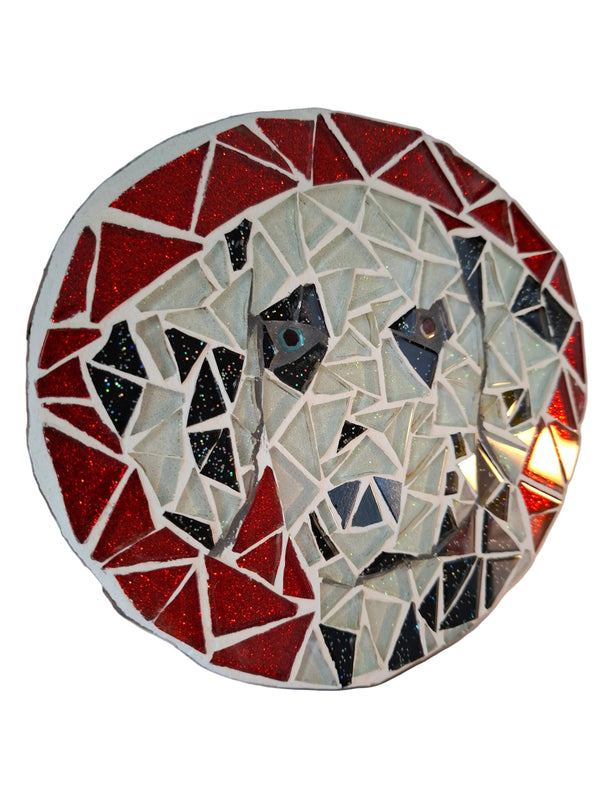 Side view of a circular dog mosaic artwork, showing the rustic wood edge.