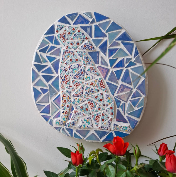 Dog mosaic on the wall surrounded by plants