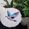 Dove mosaic on the table surrounded by plants