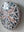 Side view of a circular dragonfly mosaic artwork, showing the rustic wood edge.