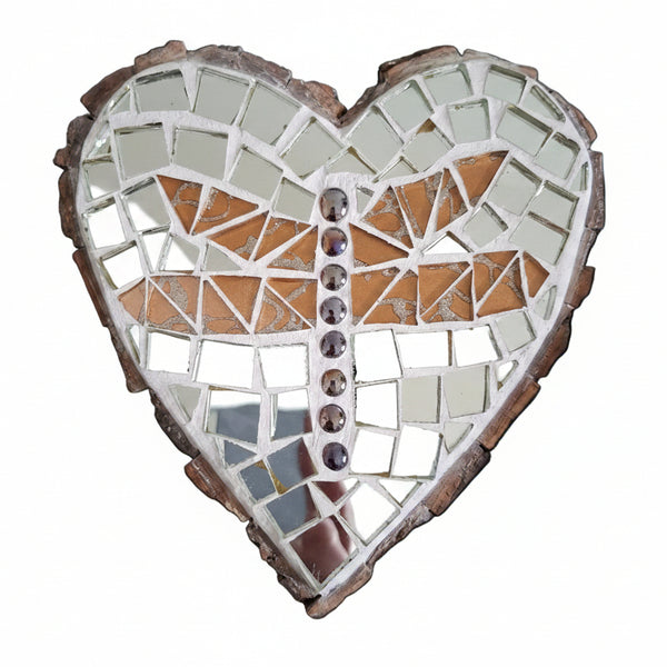 Heart shaped mosaic wall art featuring a stylized dragonfly design. Crafted with glittery gold glass pieces and iridescent gems on a reflective silver mirror background, set on rustic wood.