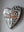 Side view of a heart shaped dragonfly mosaic artwork, showing the rustic wood edge.