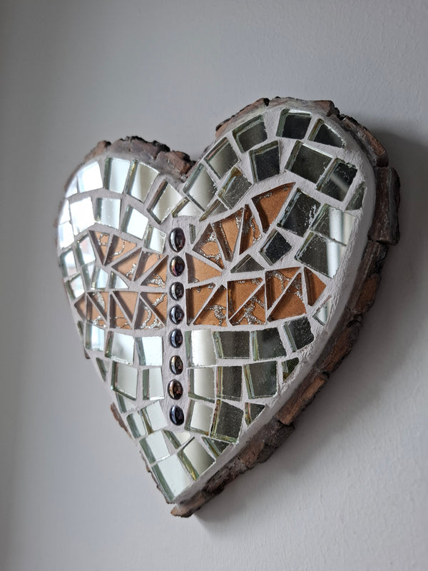 Side view of a heart shaped dragonfly mosaic artwork, showing the rustic wood edge.