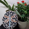 Dragonfly mosaic on the table surrounded by plants
