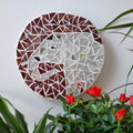Elephant mosaic on the wall surrounded by plants
