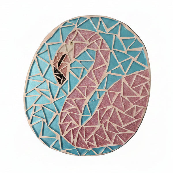 Circular mosaic wall art featuring a stylized flamingo design. Crafted with glittery pink glass pieces on a sparkly blue background, set on rustic wood.