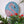 Flamingo mosaic on the wall surrounded by plants
