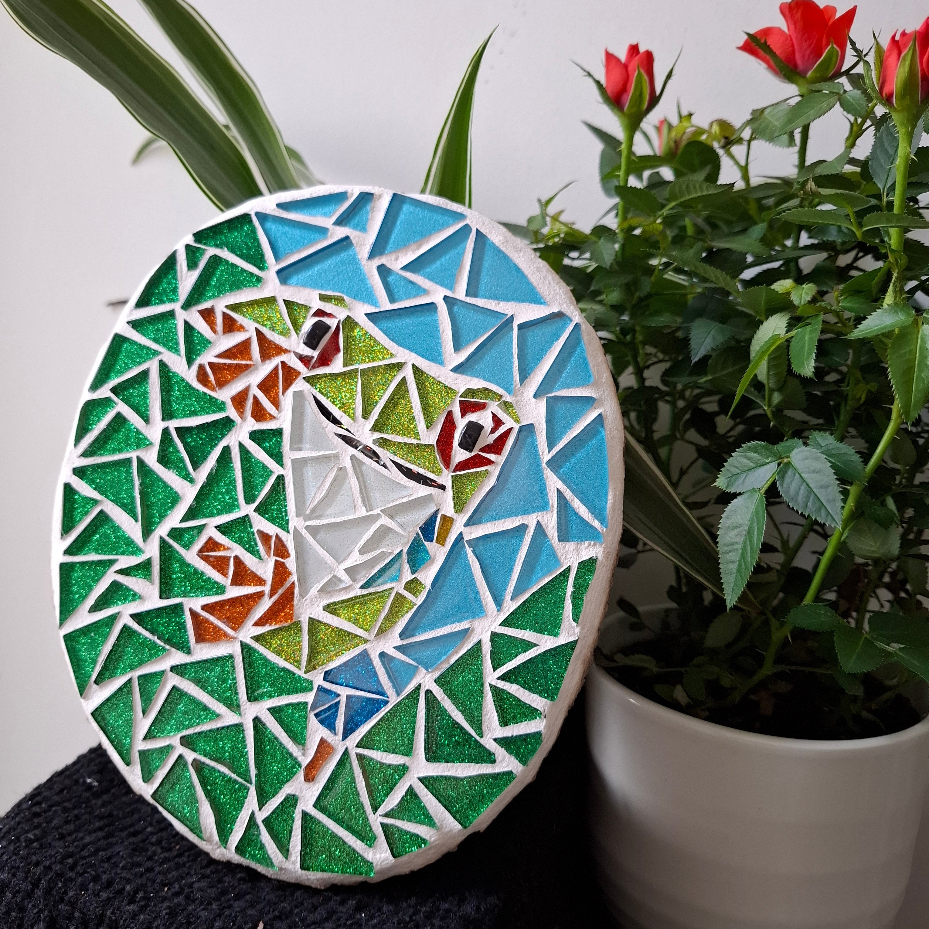 Frog mosaic on the table surrounded by plants