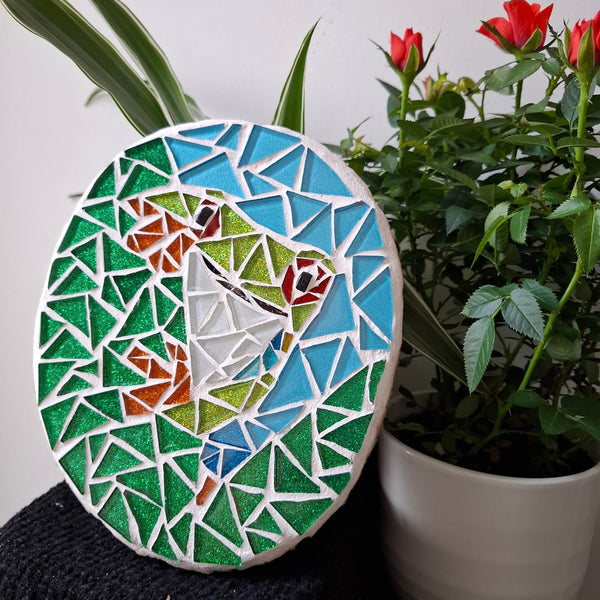 Frog mosaic on the table surrounded by plants