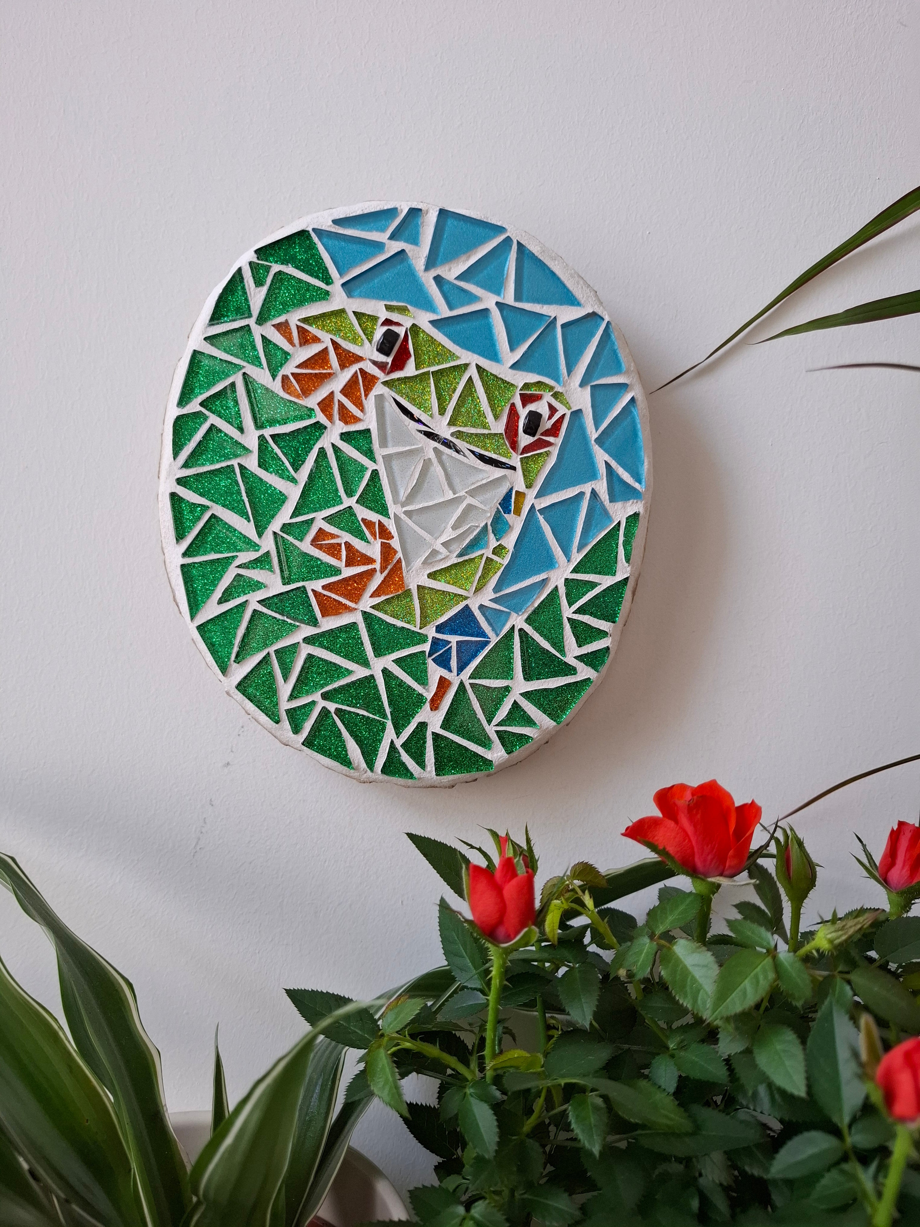Frog mosaic on the wall surrounded by plants