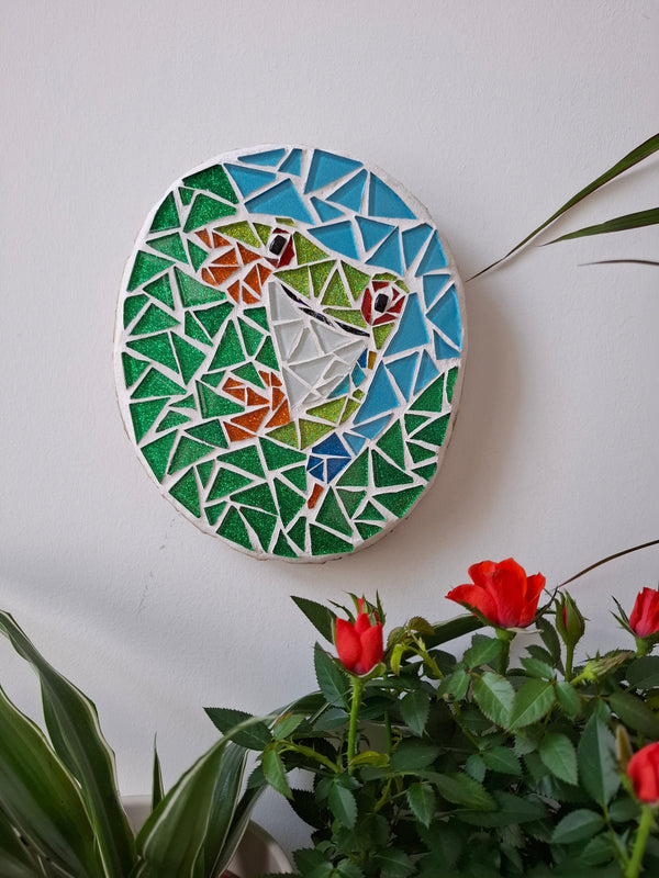Frog mosaic on the wall surrounded by plants