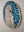 Side view of a circular parrot mosaic artwork, showing the rustic wood edge.
