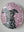 Side view of a circular dog mosaic artwork, showing the rustic wood edge.