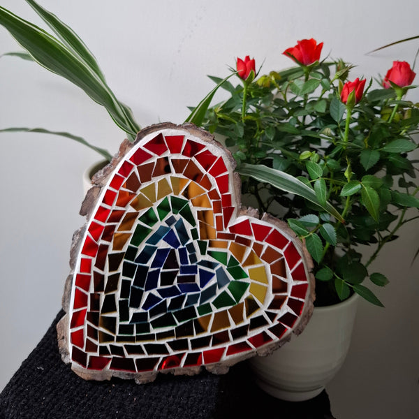 Heart mosaic on the table surrounded by plants