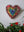 Heart mosaic on the wall surrounded by plants