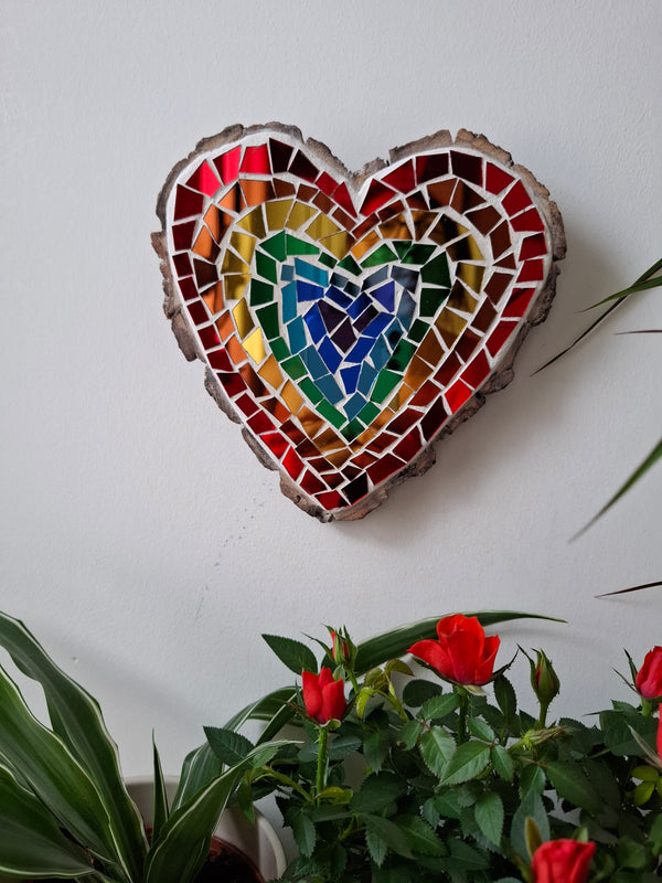 Heart mosaic on the wall surrounded by plants