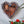 Heart mosaic on the wall surrounded by plants
