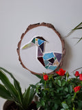 Heron mosaic on the wall surrounded by plants 