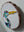 Side view of a circular heron mosaic artwork, showing the rustic wood edge.