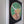 A circular wood slice mosaic wall art piece featuring a stylized highland cow, mounted on a black backing within a white frame.