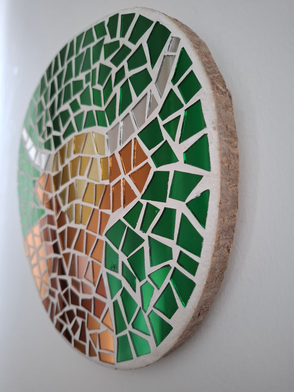 Side view of a circular highland cow mosaic artwork, showing the rustic wood edge.