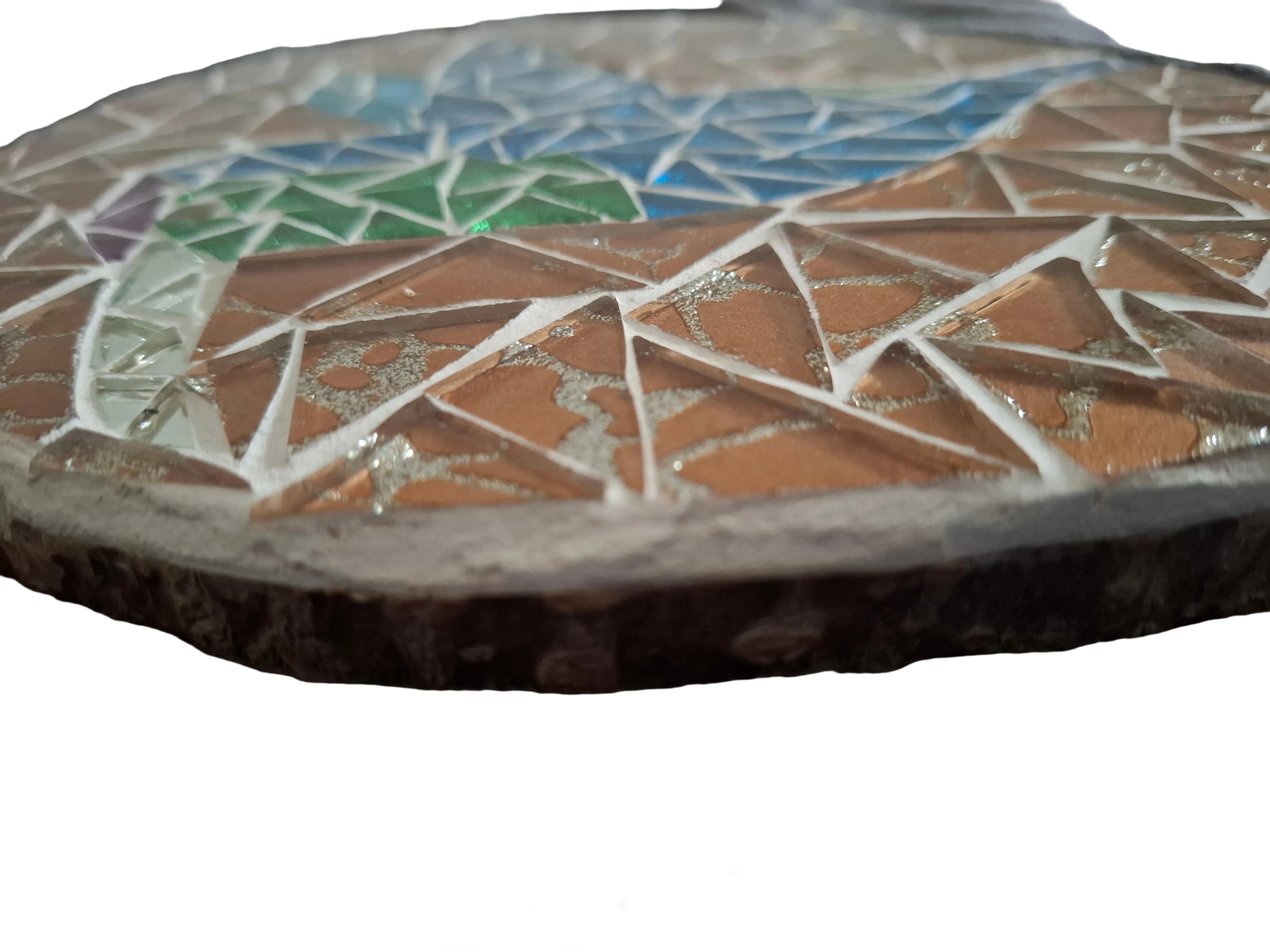 Side view of a circular bird mosaic artwork, showing the rustic wood edge.