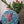 Bird mosaic on the wall surrounded by plants
