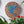 Bird mosaic on the wall surrounded by plants
