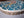 Side view of a circular bird mosaic artwork, showing the rustic wood edge.