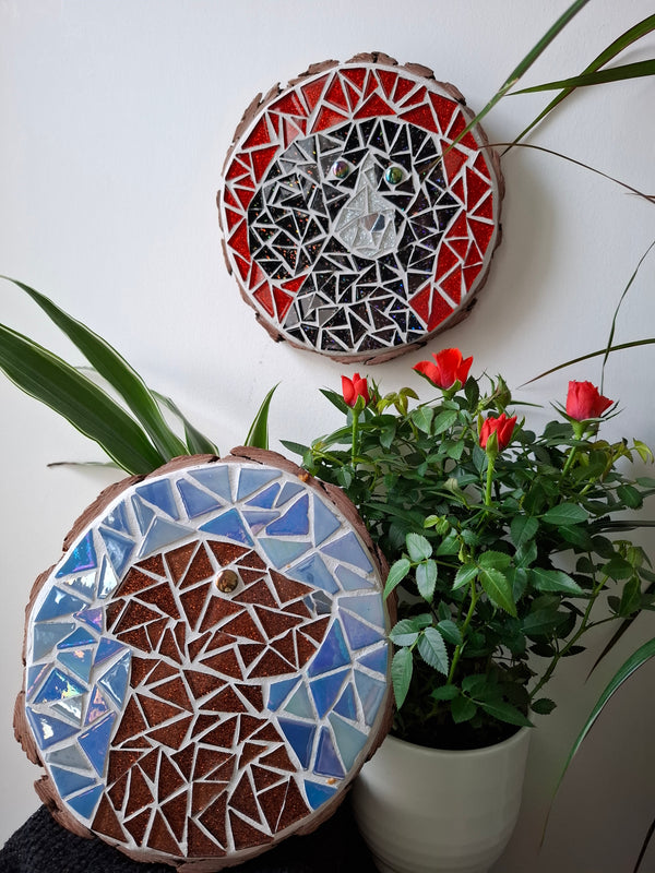 Dog mosaics on the wall surrounded by plants
