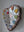 Side view of a heart shaped mosaic artwork, showing the rustic wood edge.