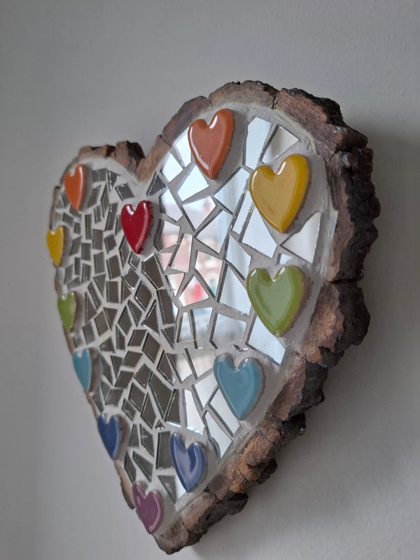 Side view of a heart shaped mosaic artwork, showing the rustic wood edge.