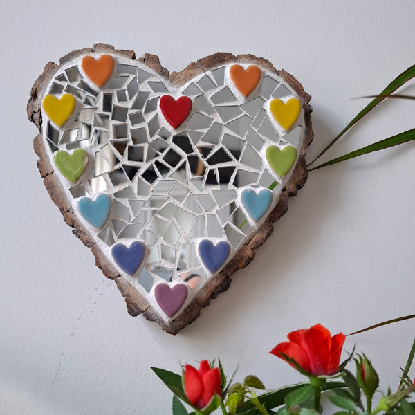 Heart mosaic on the wall surrounded by plants