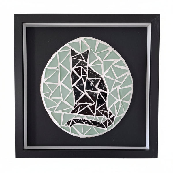 Framed mosaic wall art featuring a stylized black cat silhouette made of geometric pieces inside a circular design, set against a dark background with a black frame.