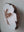 Side view of circular mosaic dove artwork, showing the rustic wood edge.