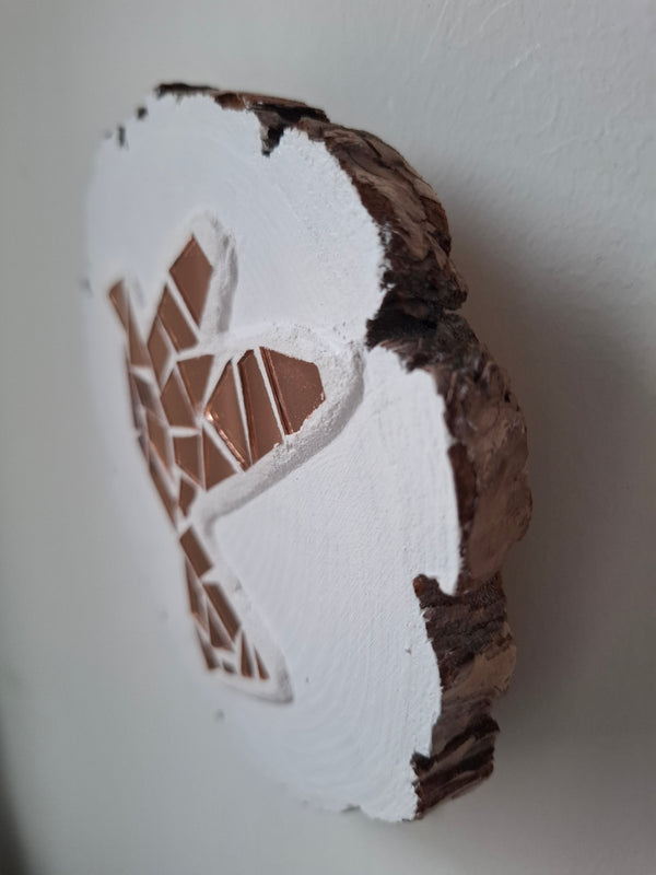 Side view of circular mosaic dove artwork, showing the rustic wood edge.