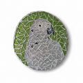 Grey parrot mosaic with silver mirror tiles and a glittery green background 